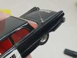 someone is holding a toy car in their hand on a table
