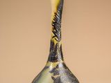 a black and yellow vase sitting on a table
