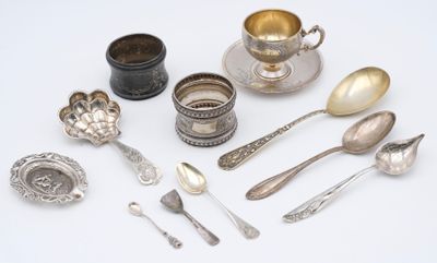 a lot of silver spoons and spoons on the table