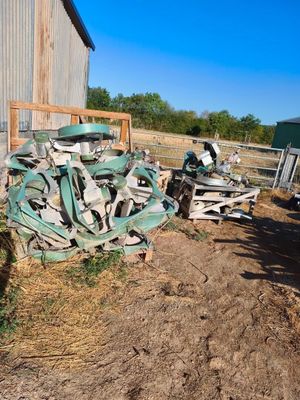un tas de vieilleries par terre, à côté d'une grange
