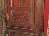 une armoire en bois surmontée d'un miroir, dans une pièce