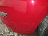 the rear end of a red car that is painted red