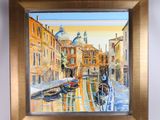painting of a canal scene with gondola boats in a golden frame