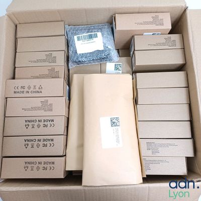 a cardboard box filled with packages and a pair of scissors