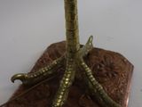 a bronze sculpture of a bird on top of a rock