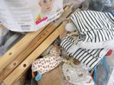a pile of baby diapers and toys in a basket