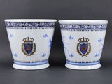 two blue and white vases with a crest on them