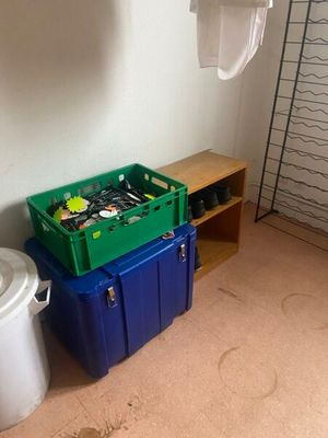 two bins and a trash can in the corner of a room