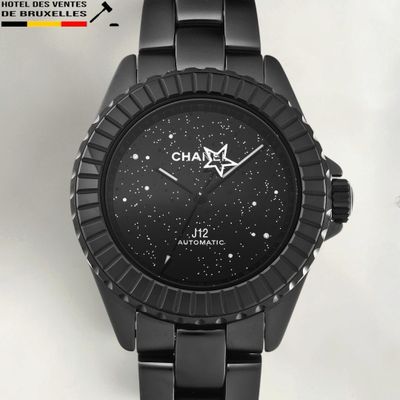the watch is black and has a white dial on the face