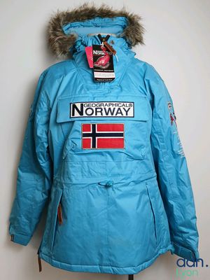 a blue jacket with a norway flag on it hanging on a wall