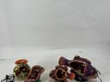 two small ceramic fish ornaments are sitting on a white surface