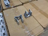 several pieces of metal sitting on top of cardboard boxes in a warehouse