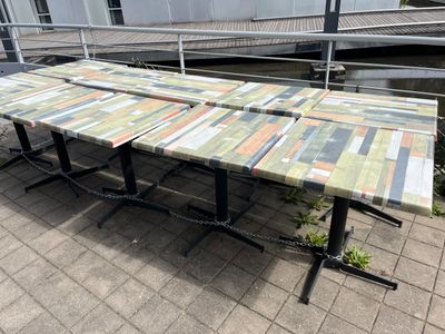 four tables that are sitting on the sidewalk