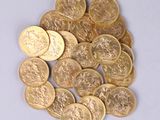 a pile of gold coins sitting on a white surface