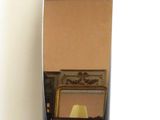 a mirror on a stand with a chair in the background