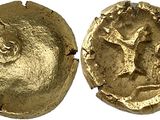 a close up of two gold coins with a tree on them