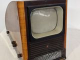 a small television sitting on top of a wooden stand