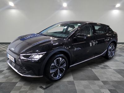 a black car parked in a room with a checkered floor