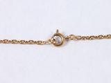 a close up of a gold chain bracelet with a heart on it