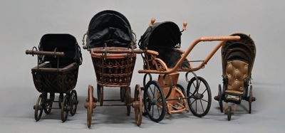 three baby strollers sitting next to each other on a white surface