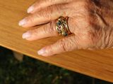 a close up of a person ' s hand with a ring on it