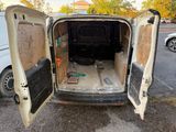 a white van with its doors open in a parking lot