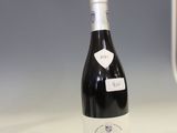 a bottle of wine sitting on a counter in a kitchen