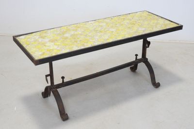 an image of a table with a yellow tile top and iron legs
