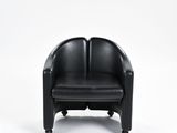 the back of a black leather chair on a white background