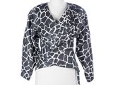 a white mannequin torso with a black and white giraffe print top
