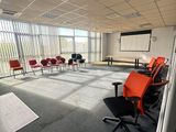 a room with chairs and a projector screen in it