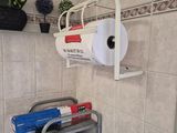 a toilet paper dispenser in the corner of a bathroom