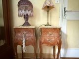 two tables with a lamp on top of them next to a door