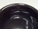 a black bowl sitting on a table with a white background