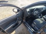 the interior of a car with the door open and the driver ' s seat down