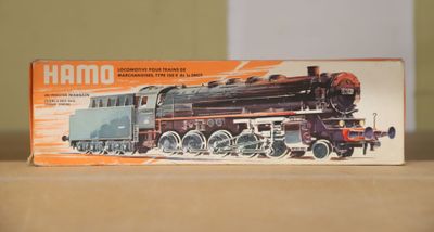 a toy train sitting on a table next to a box