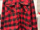 a red and black checkered shirt hanging on a hanger