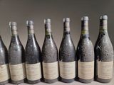 six bottles of wine are lined up in a row on a table