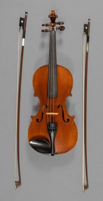 a violin that is sitting on the wall next to a bow