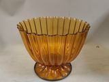 a yellow glass bowl sitting on top of a white table