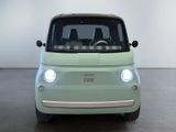 an image of a small green car in a white room
