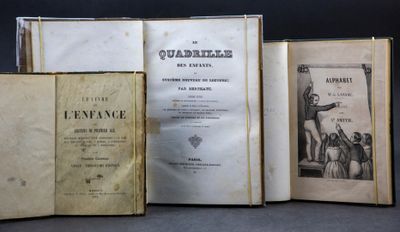 three old books sitting on top of a table next to each other