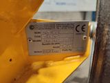 a label on the side of a yellow machine