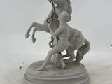 a statue of a man riding a horse on a pedestal