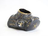 a black vase with a gold star design on it
