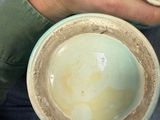 a person holding two bowls in their hands
