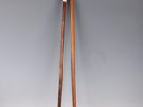 a pair of wooden chopsticks sitting on top of a white surface