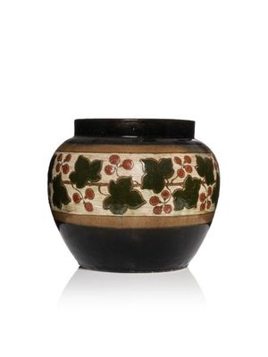 un vase noir et blanc orné de baies rouges