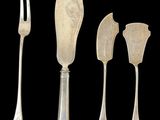four pieces of silverware including a fork, knife, and spoon
