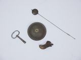 a metal object that is laying on a white surface